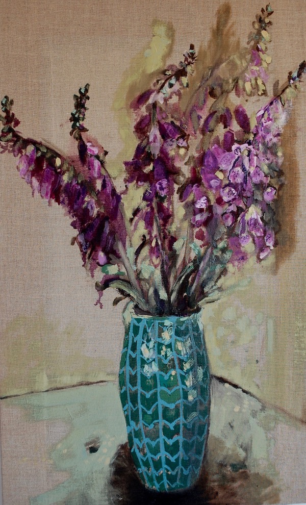 Foxgloves in a tall green vase